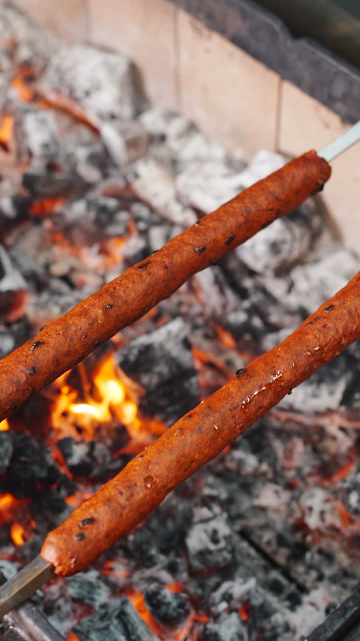 Seekh kebabs cooking over charcoal